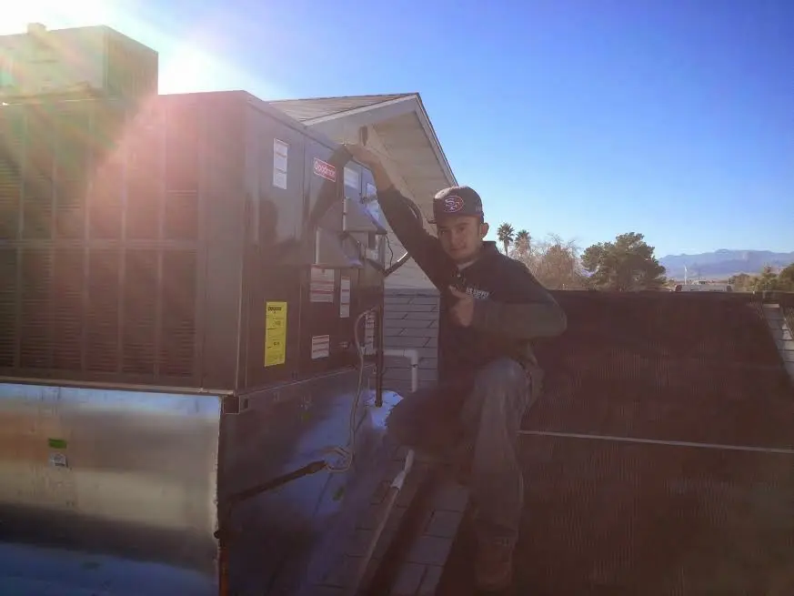 HVAC technician performing HVAC Inspection on a rooftop unit in Lehighton
